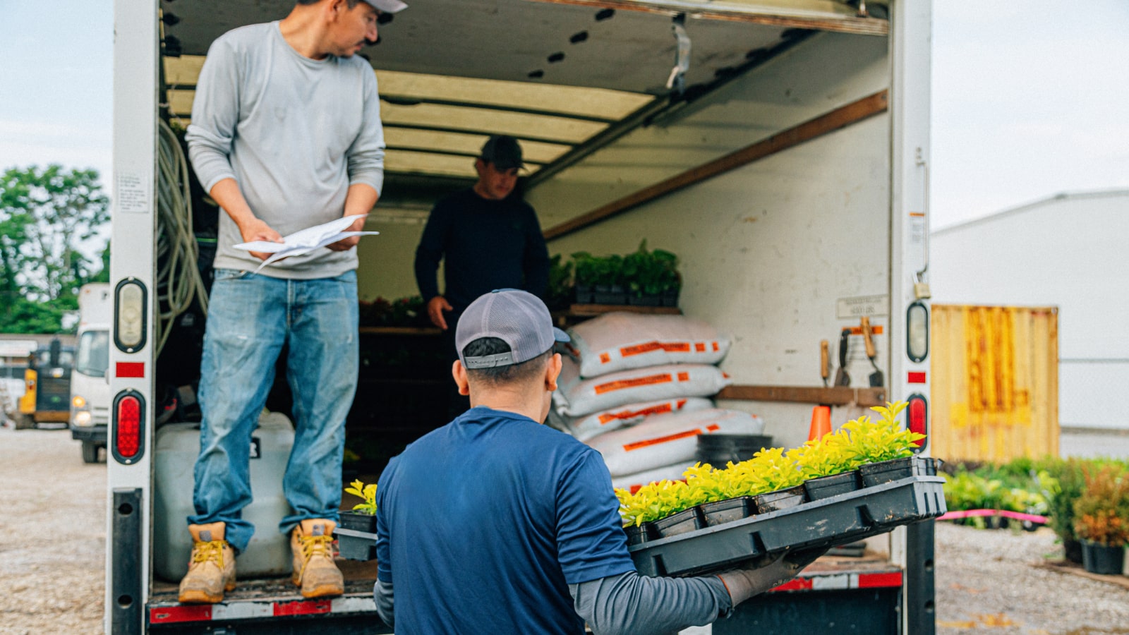 Team of landscapers unloading truck